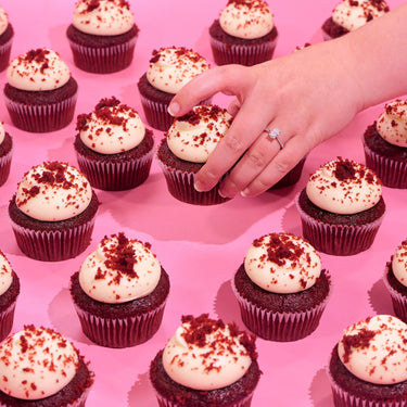 Red Velvet Cupcakes with cream cheese icing and red velvet crumbs, freshly baked by Crumbs & Doilies.